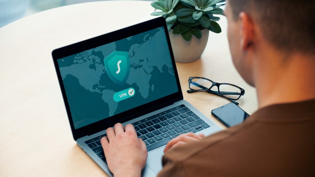 person using macbook pro on white table FastVPN Namecheap